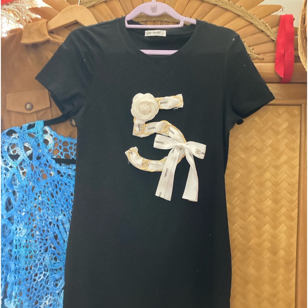 A fun adorable dress in black with (faux)Chanel 5 appliqué made of ribbon